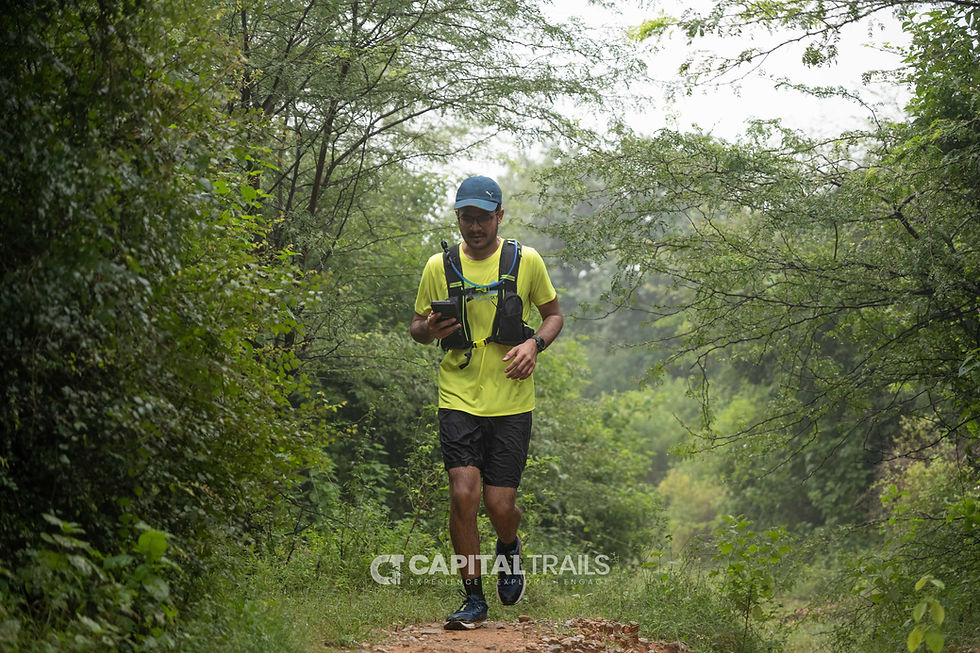 trail runner in forest navigating with phone