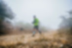 runner running on barren terrain in fog ncr Aravali