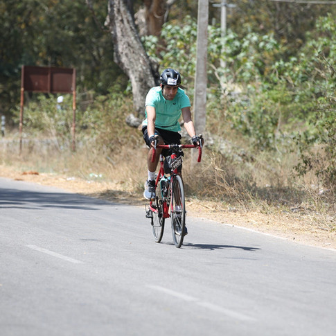 cyclist riding alone aqua top drop handlebars