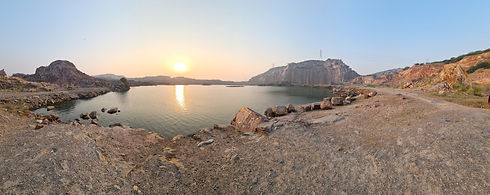 lake at sunrise surrounded by cliffs