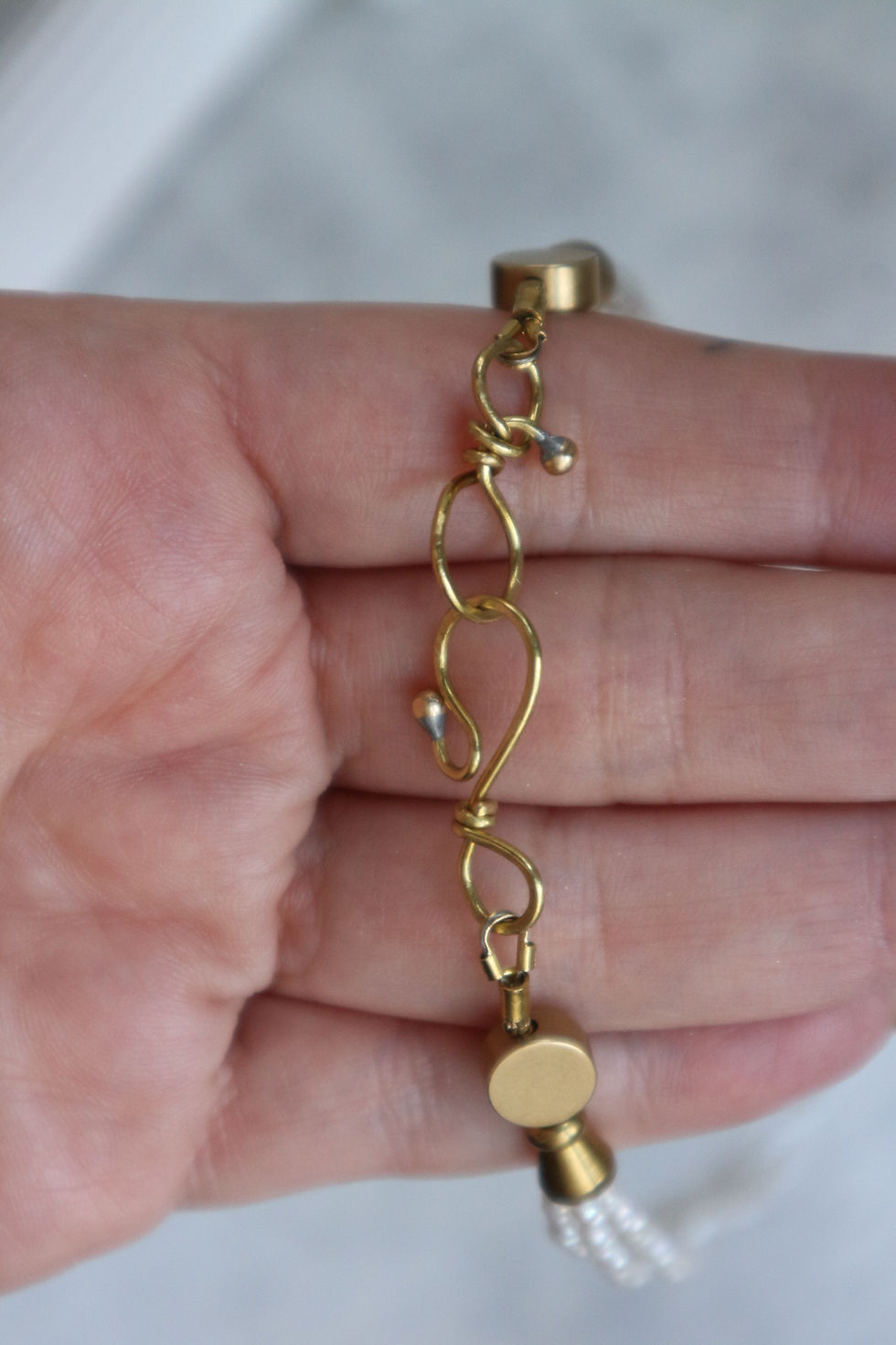 Thumbnail: Brass clasp detail on necklace