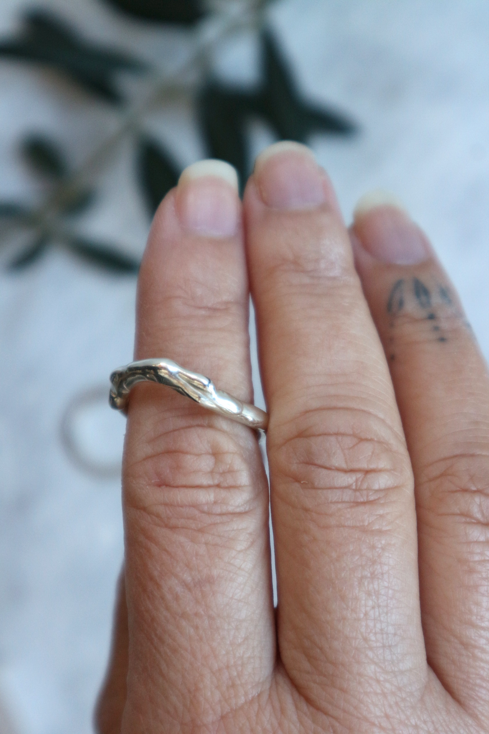 Organic style ring in silver shown on hand