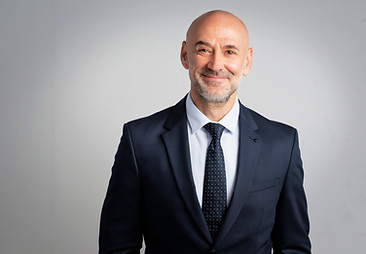 Portrait of caucasian business man looking at camera and smiling. Confident mature male pr