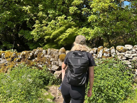 Woman carrying a heavy backpack