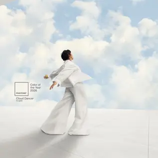 A person in white moves gracefully in a minimalist space with a sky backdrop. Text reads "Pantone Color of the Year 2026, Cloud Dancer, 11-4201."