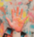 Painted hand against colorful background