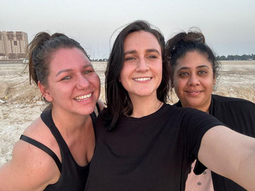 3 woman in a group photo smiling at the camera