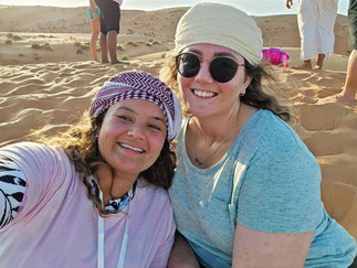 2 women laughing and posing in a desert setting