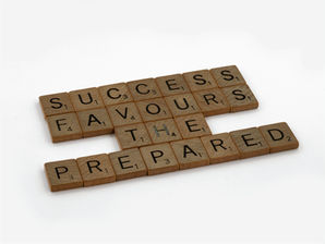 wooden letter tiles spelling out success favours the prepared