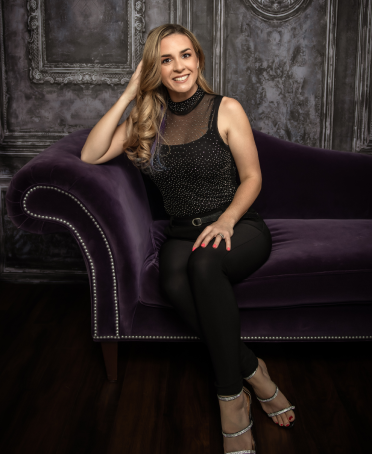 woman sitting on purple couch