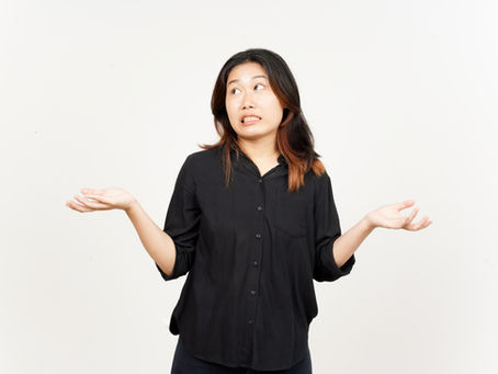 a woman with her hands up not understanding what a book is about