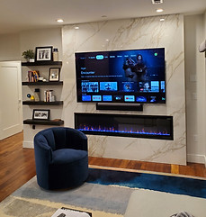 Stone Accent Wall with Fireplace and Mounted Flat Screen TV