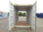 Empty white shipping container with doors open on both ends.