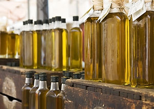 Many Olive Oil bottles on top of wooden crates