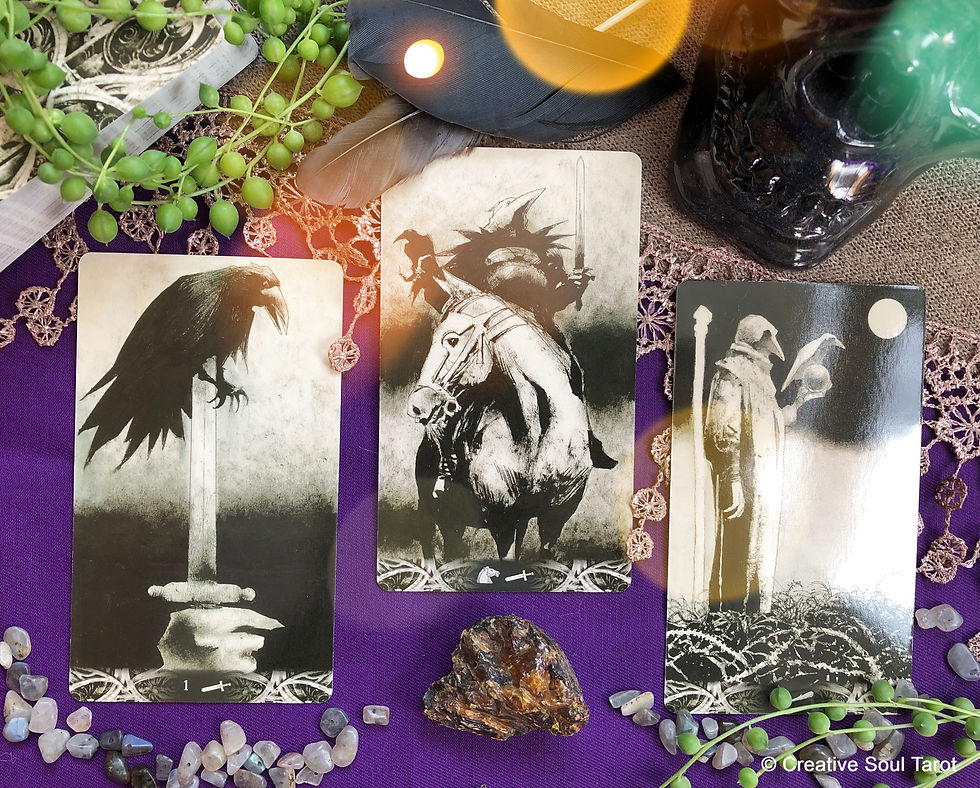Tarot cards with feathers, crystals, and a plant