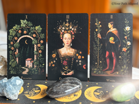 Three tarot cards with Roman numerals and labels 10 of Pentacles,The Empress, 2 of Wands, displayed with crystals on a moonlit cloth.