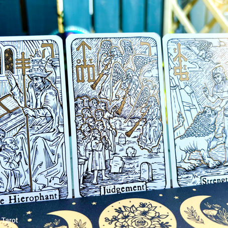 Three tarot cards: The Hierophant, Judgement, and Strength. Intricate gold and black designs, with a celestial-themed background.