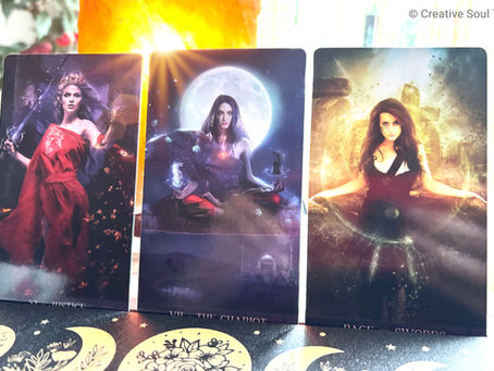 Three tarot cards: Justice, The Chariot, Page of Swords. Vibrant colors, mystical themes, woman in red dress, full moon, glowing atmosphere.