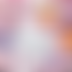 Tarot cards on pink surface with cherry blossoms, amethyst crystals, and lit candles, titled "April Tarot Inspiration." Serene mood.