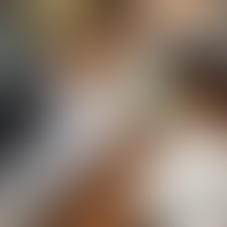 Cozy workspace: laptop, tarot cards, coffee with latte art, candle, cookies, and a notebook with pen on a wooden table. Warm and inviting mood.