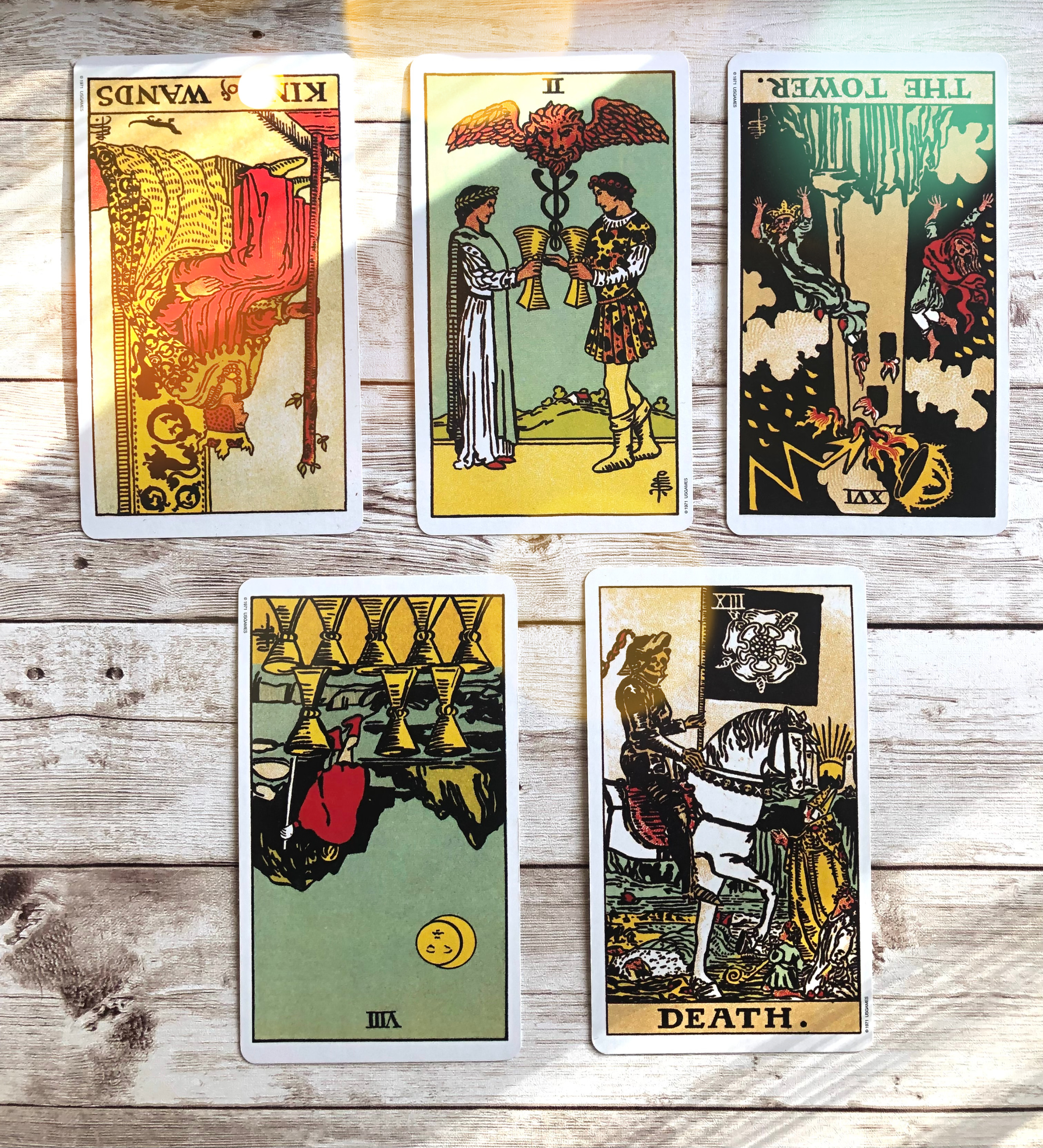 A person holding a tarot deck, preparing to read reversed cards