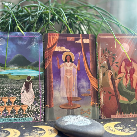 Three tarot cards against a green plant background. Cards show mystical scenes and figures. Text: "Eight of Cups" and "The Hierophant" and "Page of Wands".