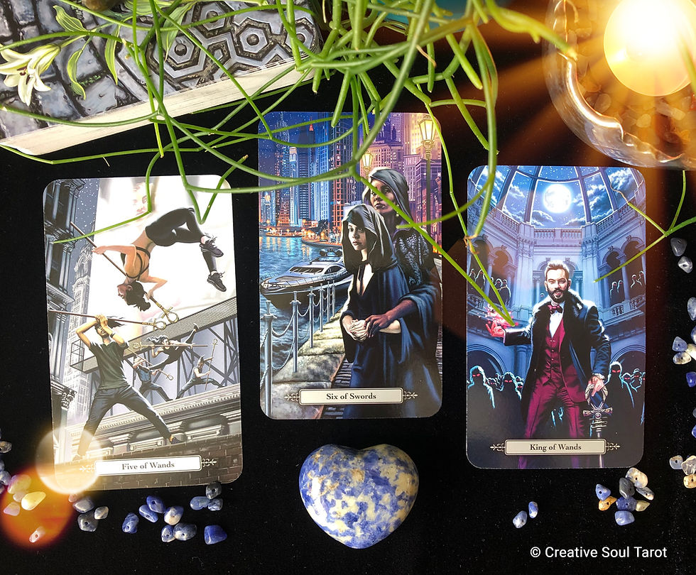 Tarot cards with candles, crystals, and a plant
