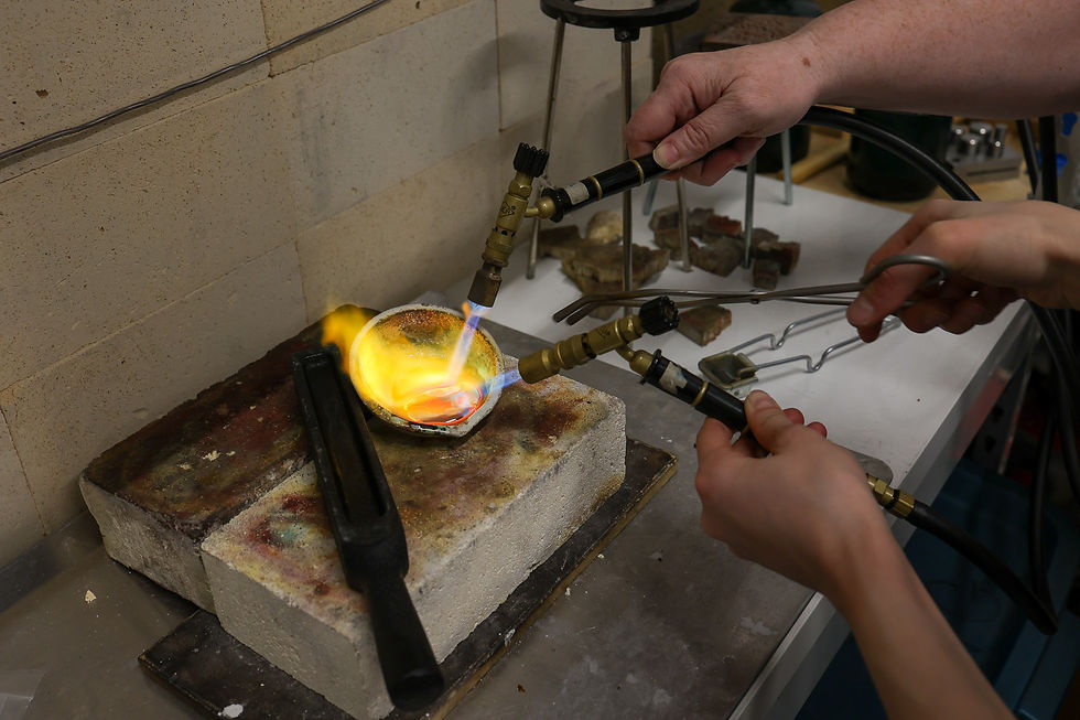 "We need more fire!" Residents Alessandra Mei and Wendy Davey collaborate on pouring an ingot.