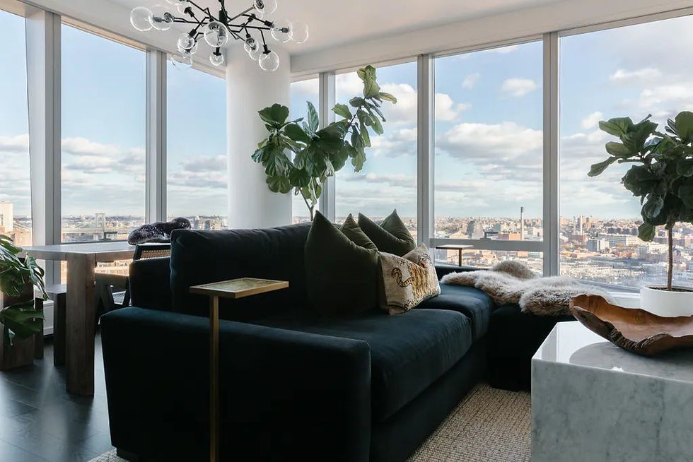 Sunlit living room with linen curtains, marble coffee table, and candles — curated environment for luxury slow living.