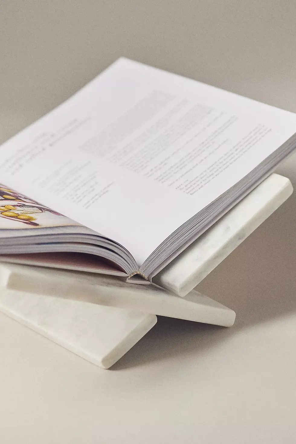 “Marble and gold cookbook stand from Anthropologie, a beautiful kitchen accessory for following recipes hands-free.”