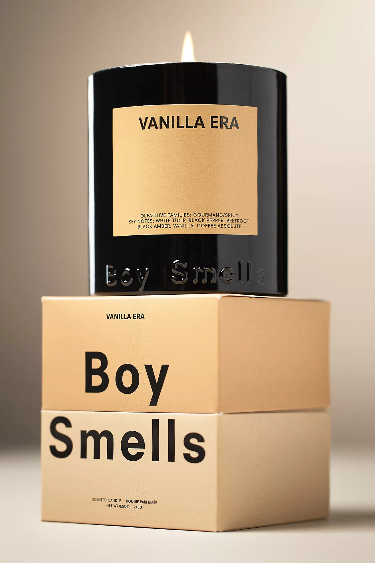 Boy Smells Vanilla Era candle in a glossy black jar stacked on branded beige boxes, highlighting its warm gourmand scent and sleek minimalist packaging.