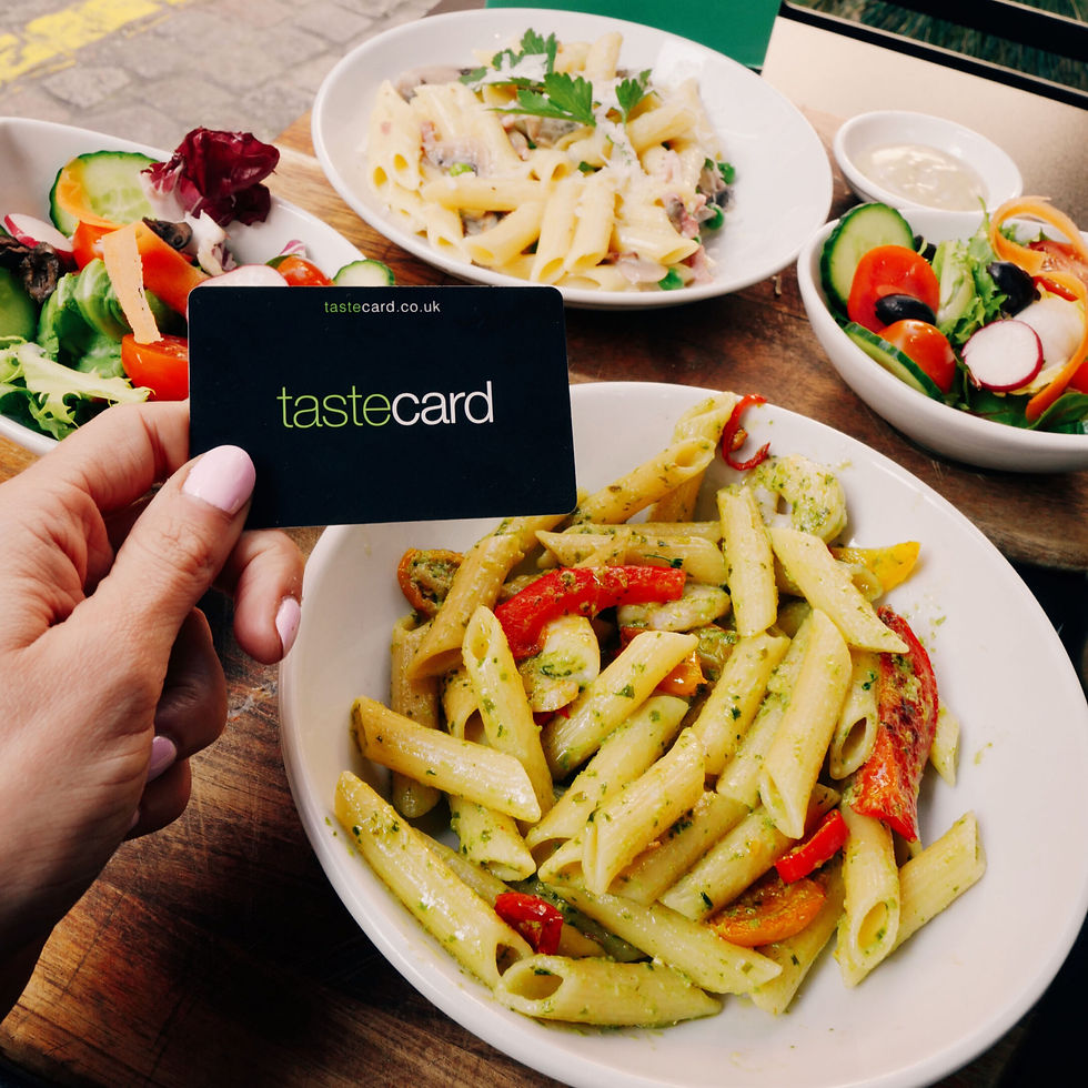 Taste card infront of a bowl of pasta and a salad