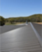 Severe hail damage to metal roof in Ada, Oklahoma after hail tornado storm. Custom roof repair.