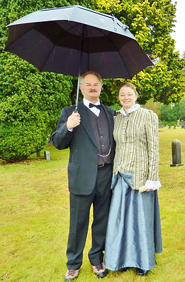 Two people dressed in period costumes for Talking Tombstones event