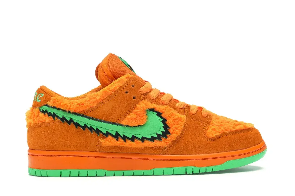 Orange and green furry Nike Dunk Low, jagged green swoosh.