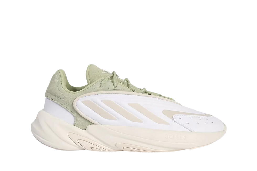 White and light green Adidas sneaker with chunky sole.