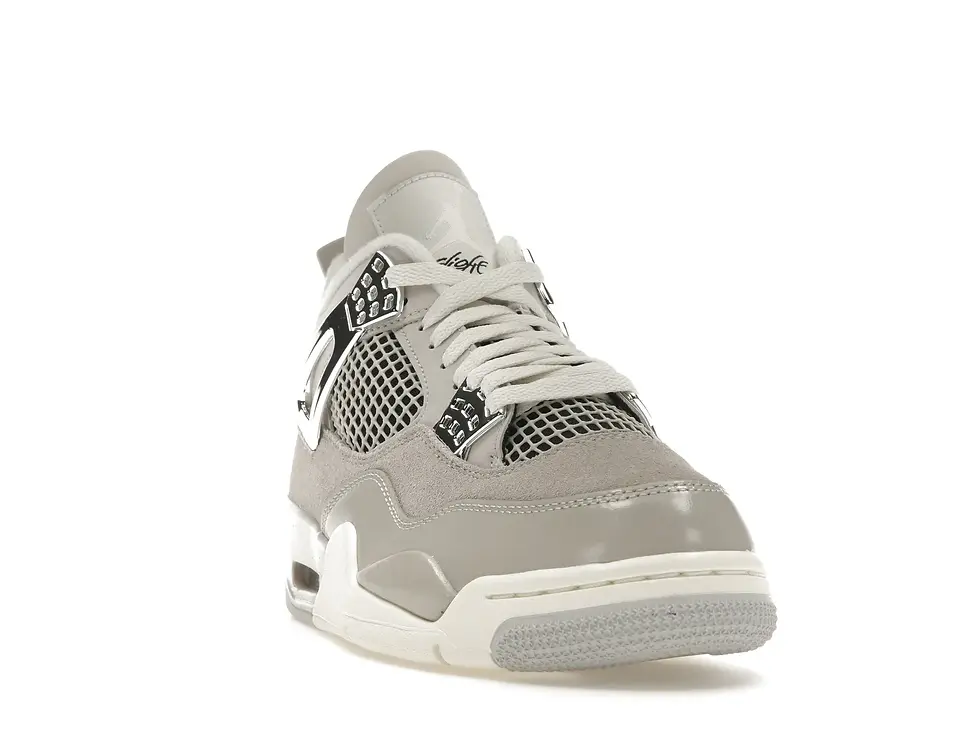 Light grey patent leather Air Jordan 4 sneaker on a white background.