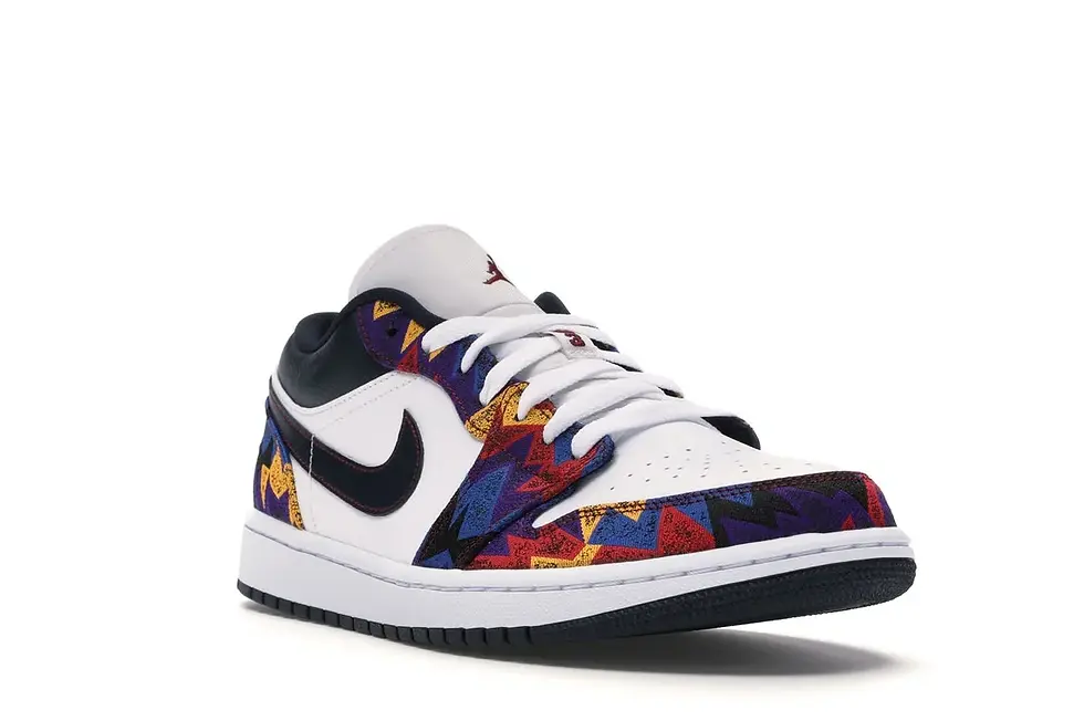 White low-top sneaker featuring a multi-colored geometric pattern and black swoosh.