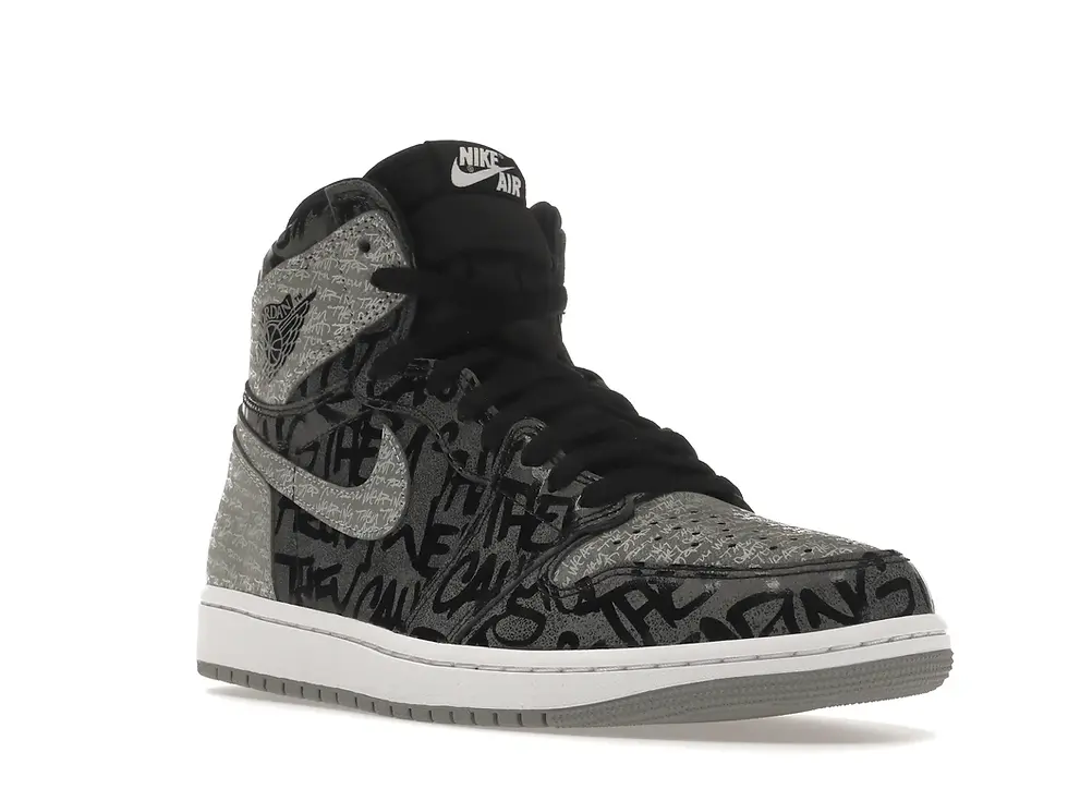 Black and grey Nike Air Jordan high-top sneaker with 'THE REASONS' graffiti.