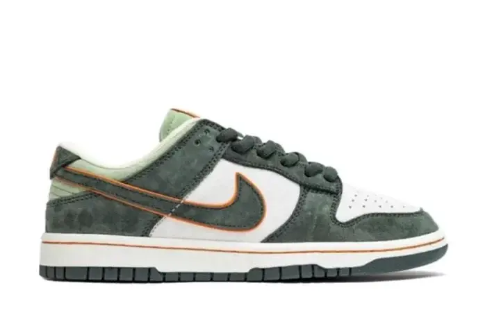 Nike Dunk Low sneaker with green white and orange accents on white background.
