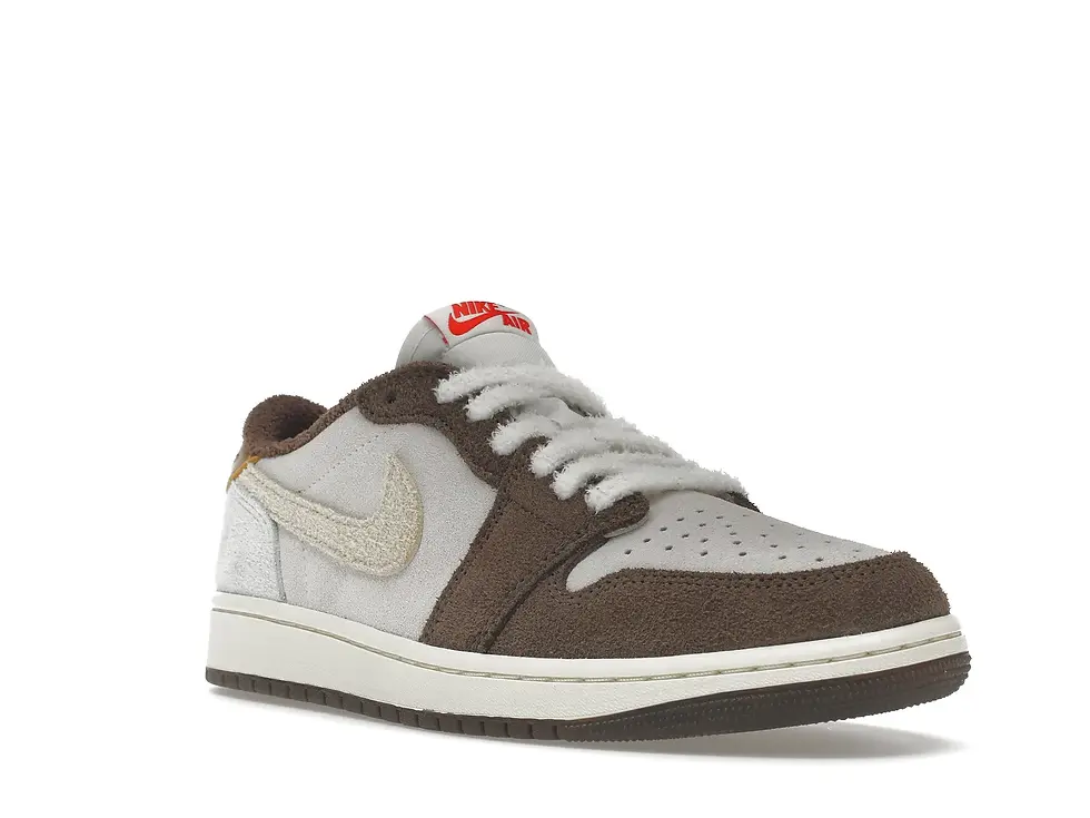 Brown and grey Nike low-top sneaker with red NIKE tongue logo.