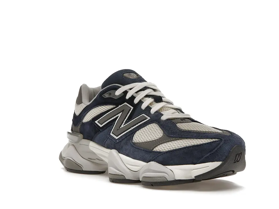 Single New Balance dark blue and gray athletic sneaker, side view.