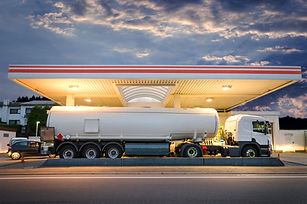 Tanker gas truck delivering fuel at serv