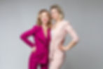 pretty-caucasian-female-friends-white-pink-suits-smile-picture-isolated-grey-wall.jpg