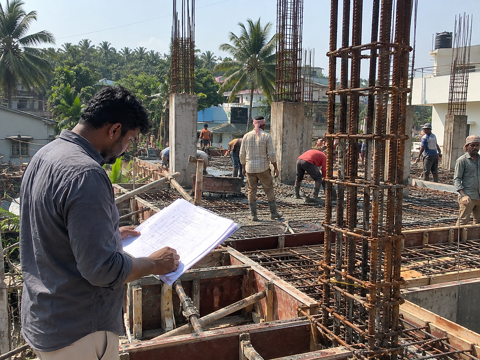 Engineers reviewing structural blueprints on-site in Kerala