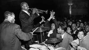 Cootie Williams plays his trumpet in a crowed Harlem ballroom with Duke Ellington's band, circa 1930.