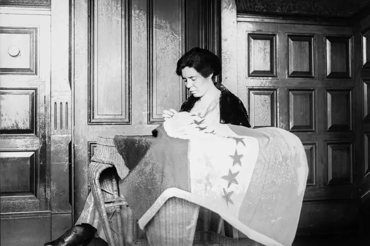 Alice Paul sews a Suffrage Flag in Washington, D.C., 1920