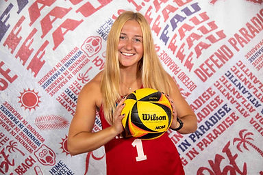 Coach Alivia Orvieto posing with a volleyball