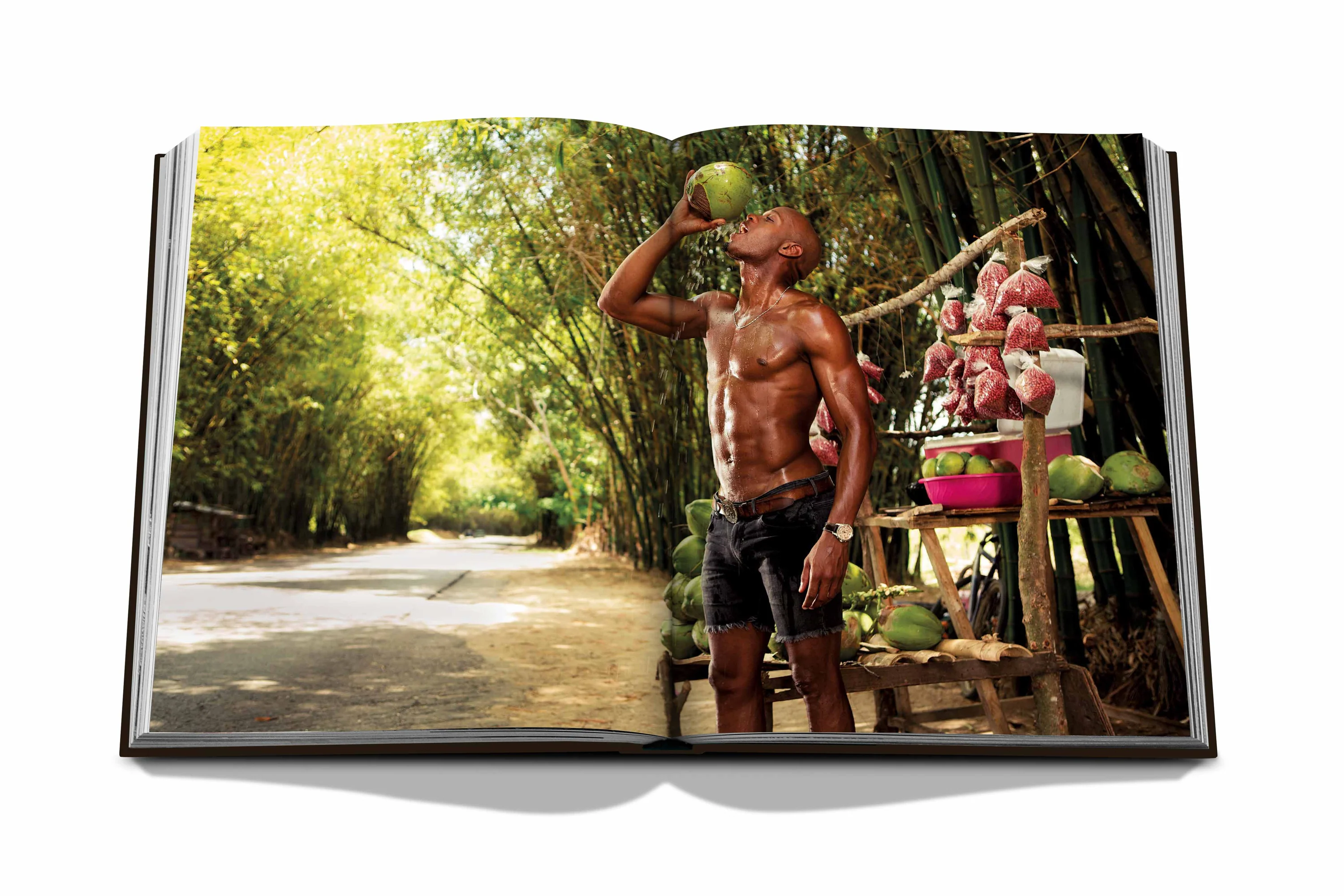 A spread in the Jamaica Vibes book showing a muscular athlete drinking from a coconut in Jamaica