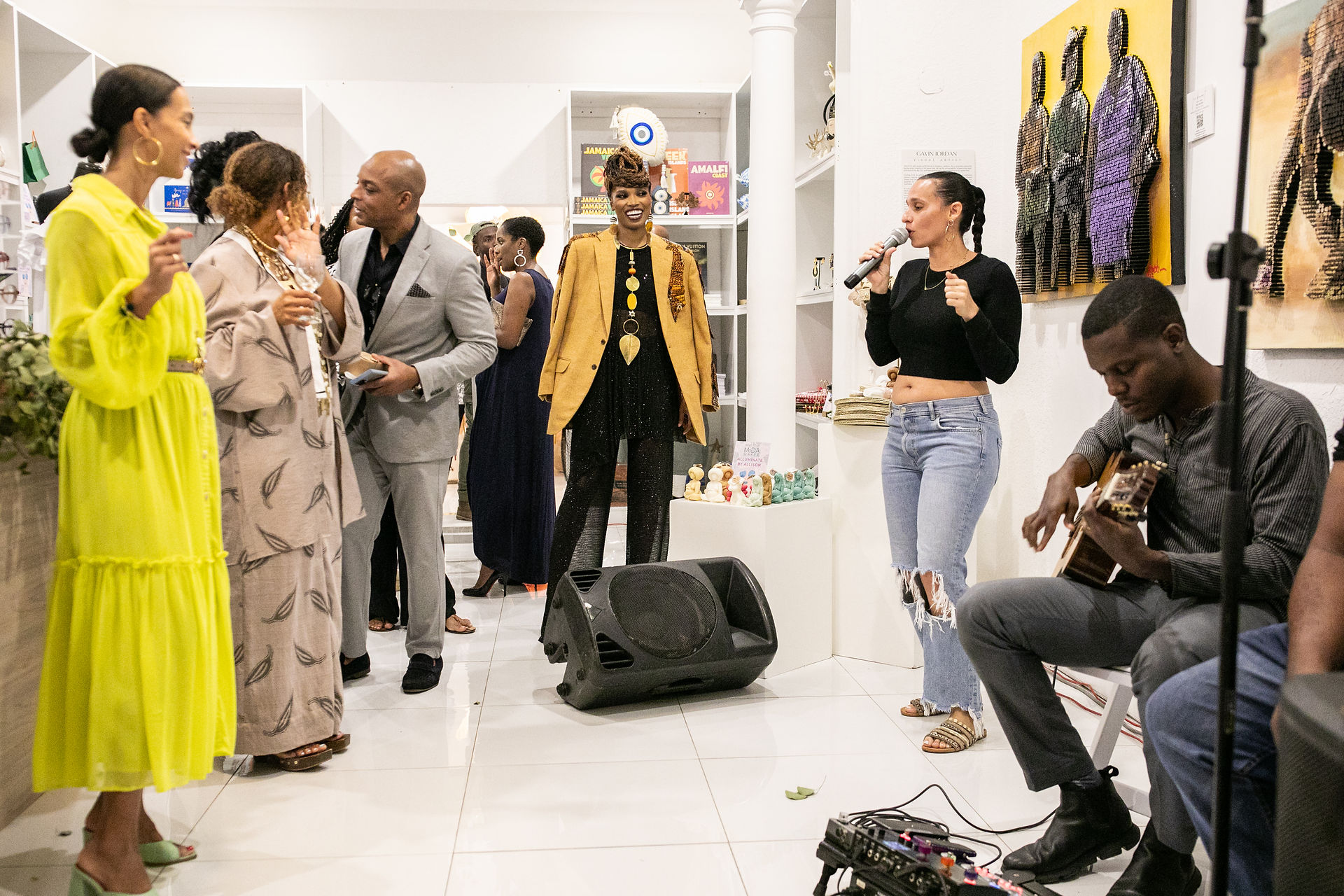 guests at fashion showcase gather around Jamaican soul crooner Sarah Couch
